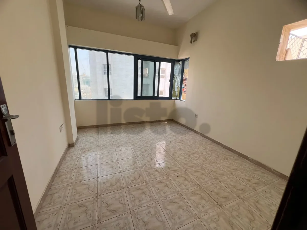 Two bedrooms and a hall for rent in Al Butina, Sharjah, with a wide area and split air conditioning.